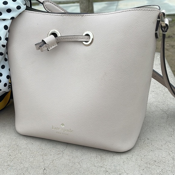 kate spade Handbags - KATE SPADE BEIGE bucket bag leather crossbody straps used a month 8”x9”